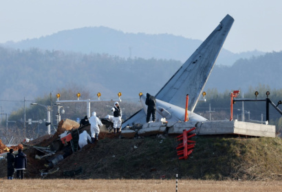 Officials investigate the site where a Jeju Air Boeing 737-800 aircraft crashed and burst into flames at Muan airport