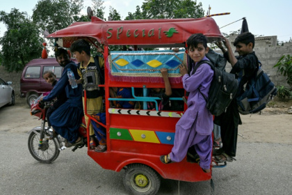 Students travel home from a community school in Abdullah Goth village on the outskirts of Karachi