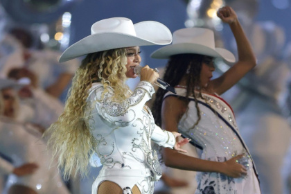 Beyonce, shown here performing with her daughter Blue Ivy during an NFL game on Christmas Day 2024, is the artist with the most Grammys ever