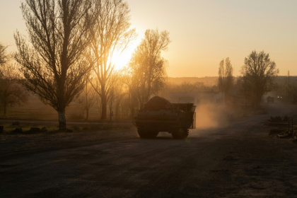 An armoured Ukrainian military vehicle drives on a road in a village not far from the frontline in the Dnipropetrovsk region, on April 19, 2025