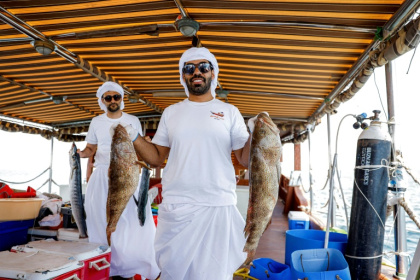 A Qatari contestant shows off his catch in a line-fishing competition that forms part of a festival aimed at reviving the emirate's sea-faring tradition. - Karim JAAFAR (AFP)