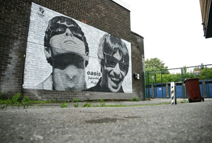 Street artwork depicting the Oasis brothers Liam and Noel Gallagher, created by Manchester-based street artist, Pic.One.Art, pictured in August 2024 on the side of Sifters Record store in Burnage, Manchester - Paul ELLIS (AFP)