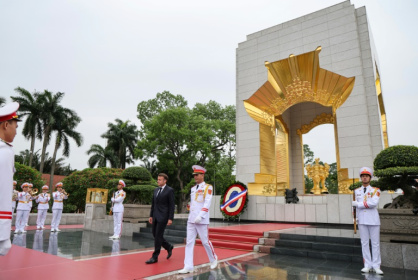 After paying tribute at a Hanoi war memorial to those who fought against French colonial occupation, the French president has a day of talks ahead - Ludovic MARIN (AFP)