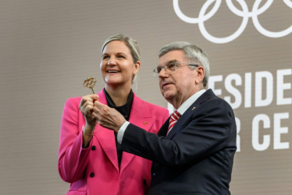 International Olympic Committee President Kirsty Coventry receives the ceremonial key from outgoing IOC President Thomas Bach during the handover ceremony - Fabrice COFFRINI (AFP)