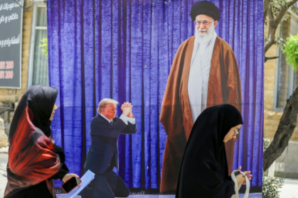 A poster depicting US President Donald Trump prostrating in front of Iran's Ayatollah Ali Kamenei hangs in a southern Beirut suburb - - (AFP)