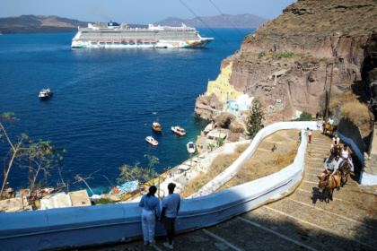 A cruise ship off the Greek island of Santorini, which is among the destinations for which cruise ships will now pay tourist taxes - ARIS OIKONOMOU (AFP)