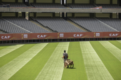 A groundkeeper puts the finishing touches to the pitch in Nairobi ahead of the African Nations Championship - SIMON MAINA (AFP)