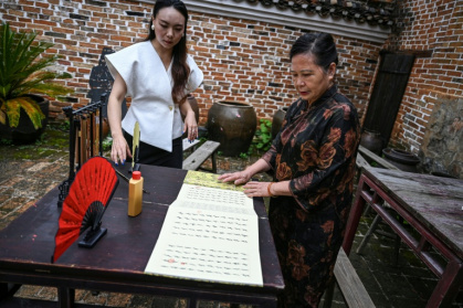 Passed down through generations of women in the remote and idyllic county of Jiangyong, Nushu is now gaining popularity nationwide - Jade GAO (AFP)