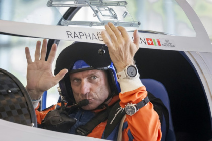 Swiss pilot Raphael Domjan waved to friends and family prior to take-off - Fabrice COFFRINI (AFP)