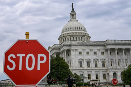 A stop sign is seen in front of the US Capitol -- where talks to reopen the federal government have seen little progress - Alex WROBLEWSKI (AFP)