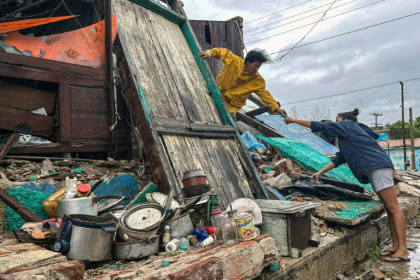 A family salvages belongings from the rubble of their home after it collapsed during Hurricane Melissa’s passage through Santiago de Cuba, Cuba - YAMIL LAGE (AFP)