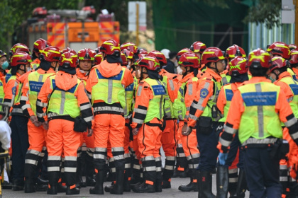 Fire department rescue teams gather after a blaze swept through several apartment blocks at the Wang Fuk Court residential estate in Hong Kong's Tai Po district - Peter PARKS (AFP)