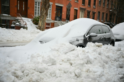 A car in Brooklyn, New York is plowed in with snow a day after a winter storm swept across the nation - ANGELA WEISS (AFP)