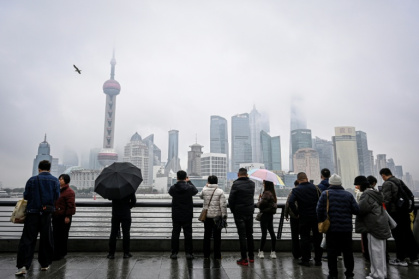 People visit the Bund promenade along the Huangpu River in Shanghai on March 5, 2026. - Jade GAO (AFP)