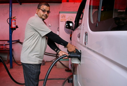Electric microbus driver Purushottam Adhikari charges his Chinese-made e-van at a charging station in Kathmandu - Prakash MATHEMA (AFP)