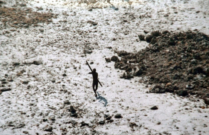 File photo of a man with the Sentinelese tribe aiming his bow and arrow at an Indian Coast Guard helicopter as it flies over North Sentinel Island in the Andaman Islands - Handout (AFP)
