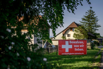 A Yes campaign banner reading in German 'Preserve what we love'. Opinion polls were predicting a tight vote - Fabrice COFFRINI (AFP)