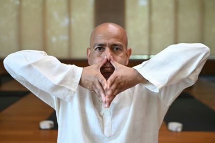 Varun Veer, founder of Lifeyoga, demonstrates 'Pranayama' at his studio in New Delhi - Arun SANKAR (AFP)